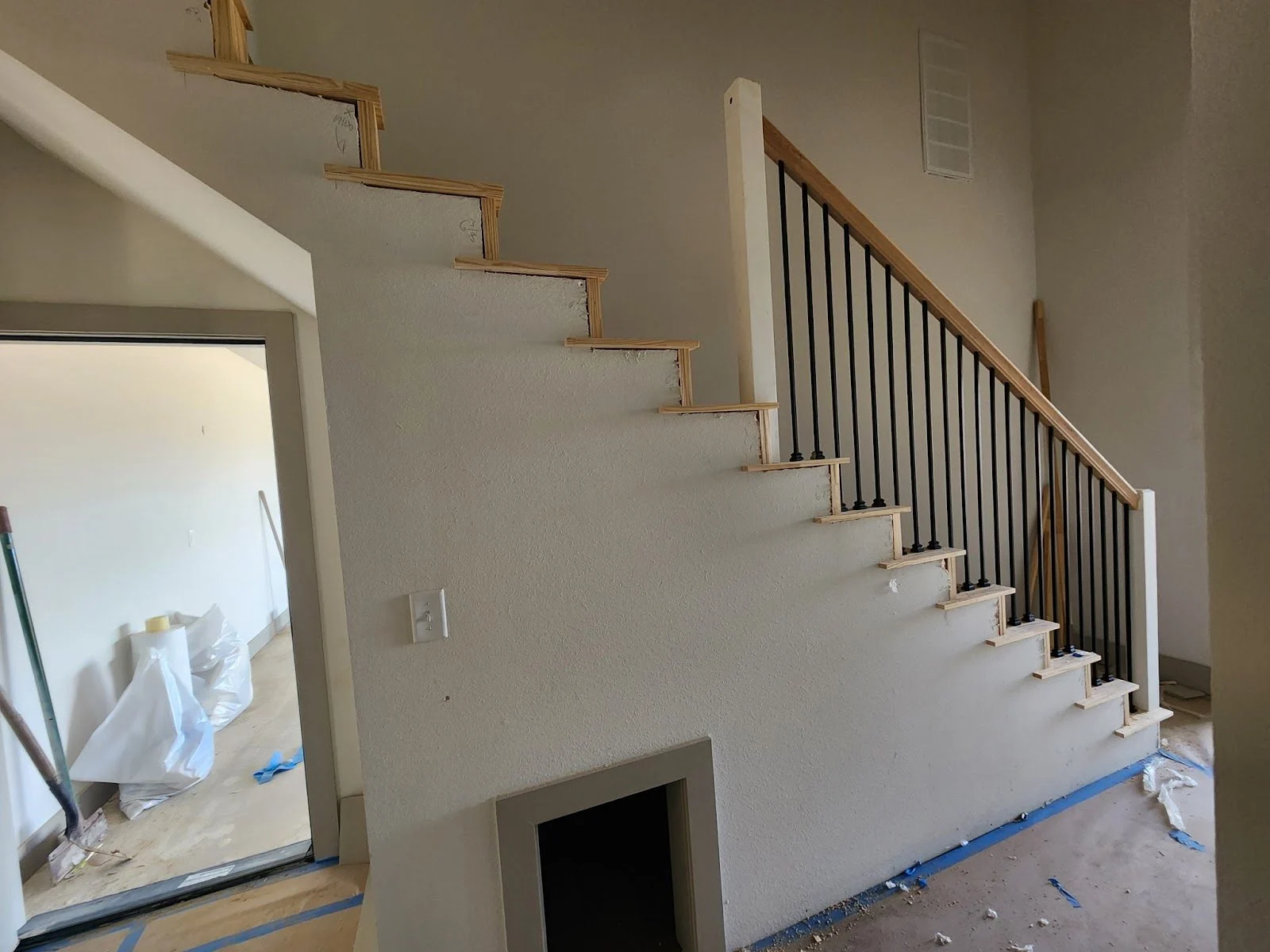 Freshly painted staircase walls and railing during a Tulsa interior repaint