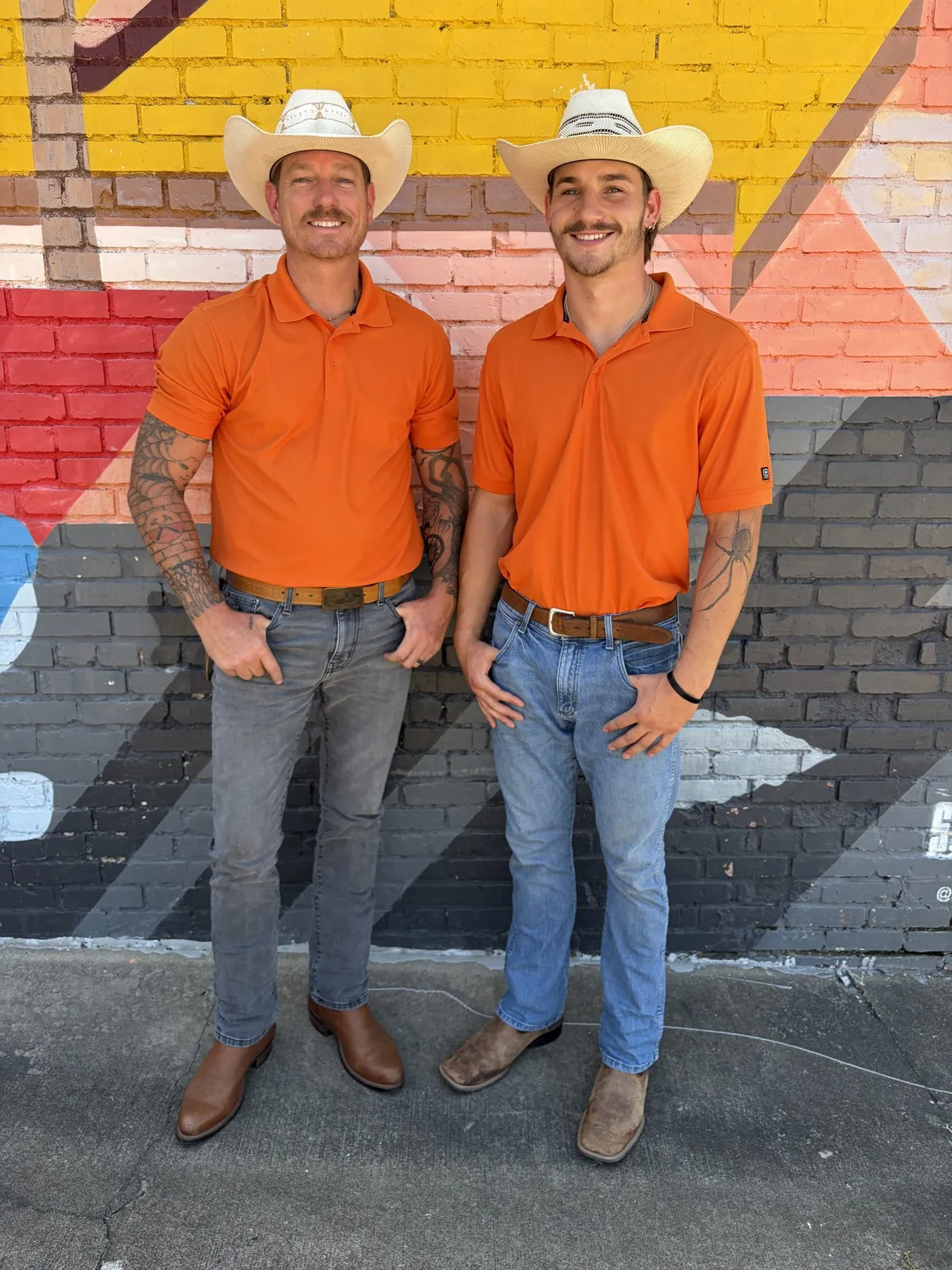 Zach Wiser and his son Shamus with the Wiser & Sons crew in matching orange shirts in Tulsa