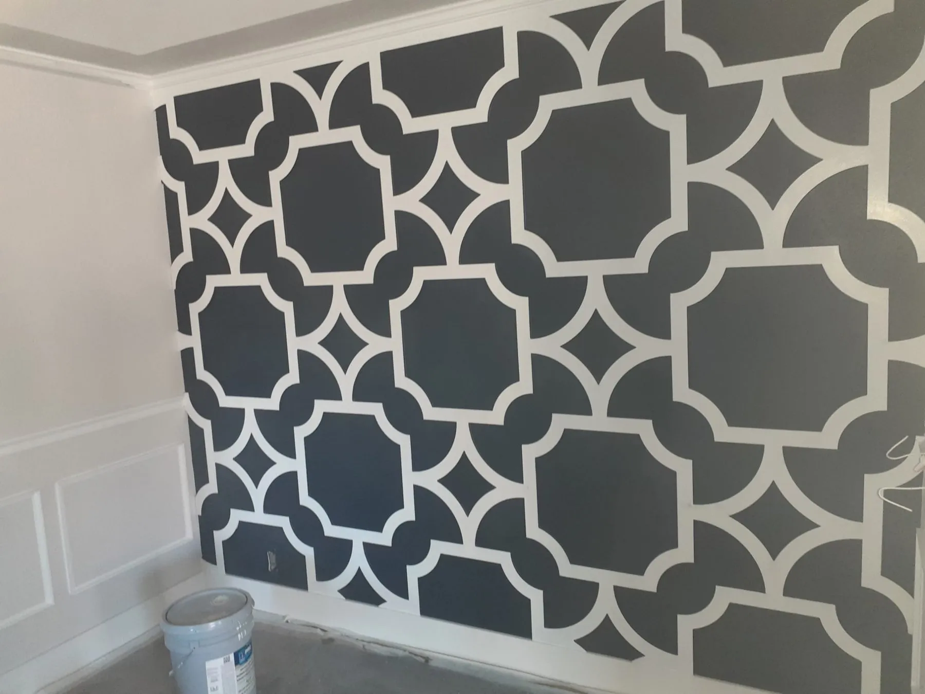 Gray and white geometric accent wall painted across a full wall in a Tulsa home