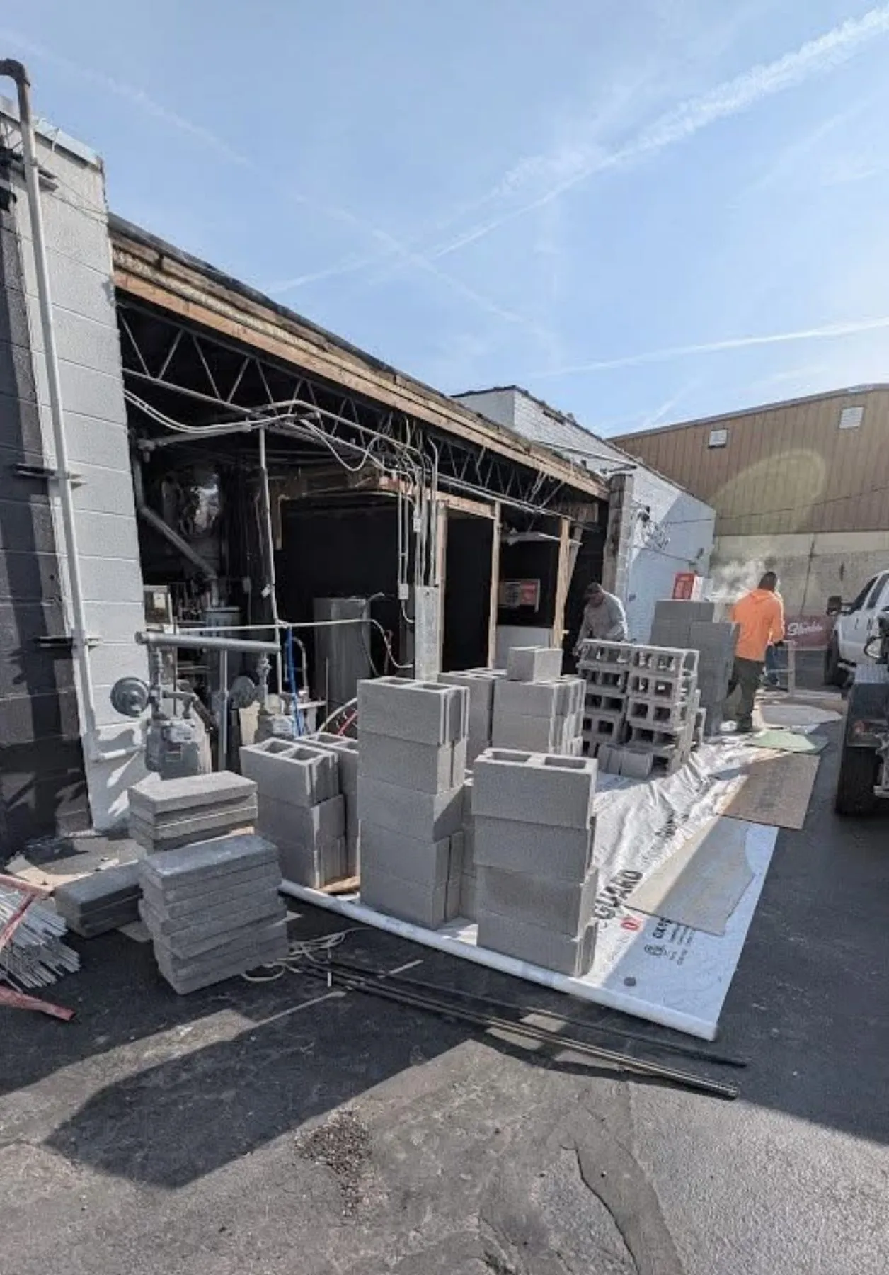 Concrete block stacked for rebuilding a vehicle-damaged wall of a Tulsa commercial building